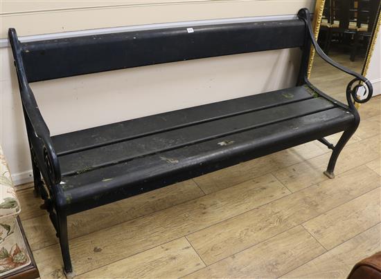 A black painted cast iron and wooden-slatted garden bench, W.165cm